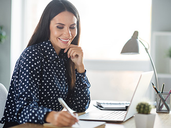 Photo of a woman smiling at a desk