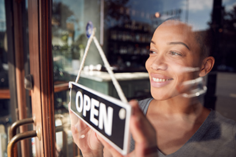 Photo of women holding a sign that says Open