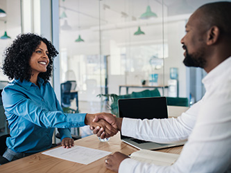 Shaking hands with a hiring candidate