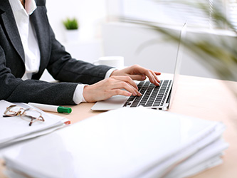 Business woman typing on a laptop